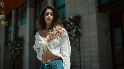 a woman in a white shirt and blue jeans