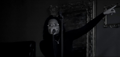 a person with a microphone in a dark room