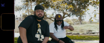 a couple of men sitting next to each other