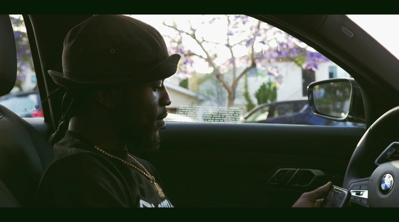 a man sitting in a car holding a cell phone