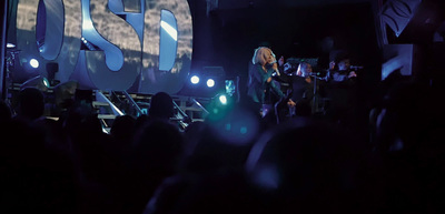 a woman standing on top of a stage in front of a crowd