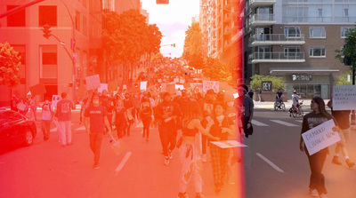 a group of people walking down a street next to tall buildings