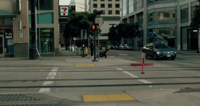 a car is driving down a city street