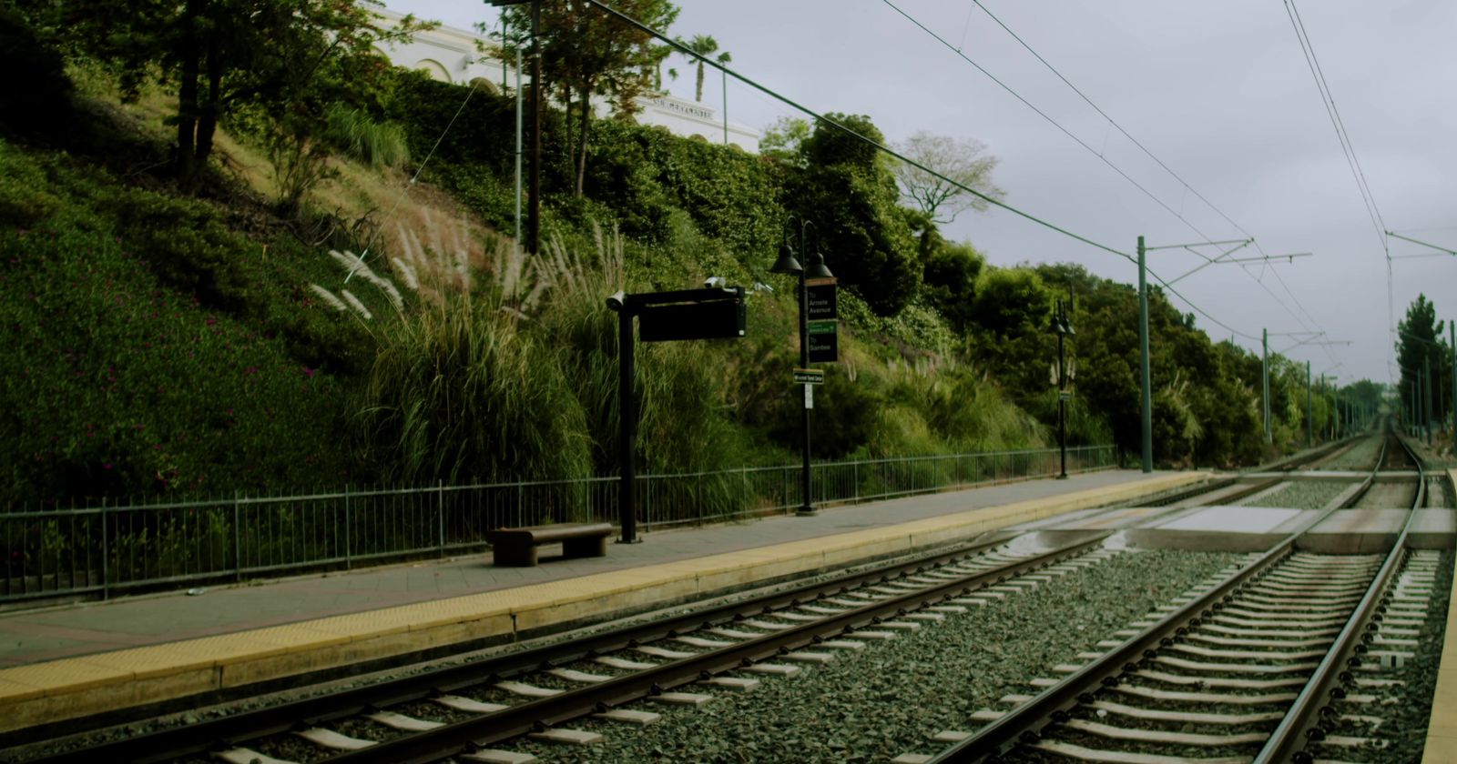 a train track with a bench on the side of it