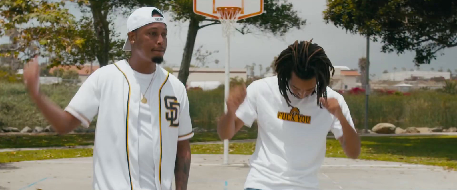 a couple of men standing next to each other on a basketball court