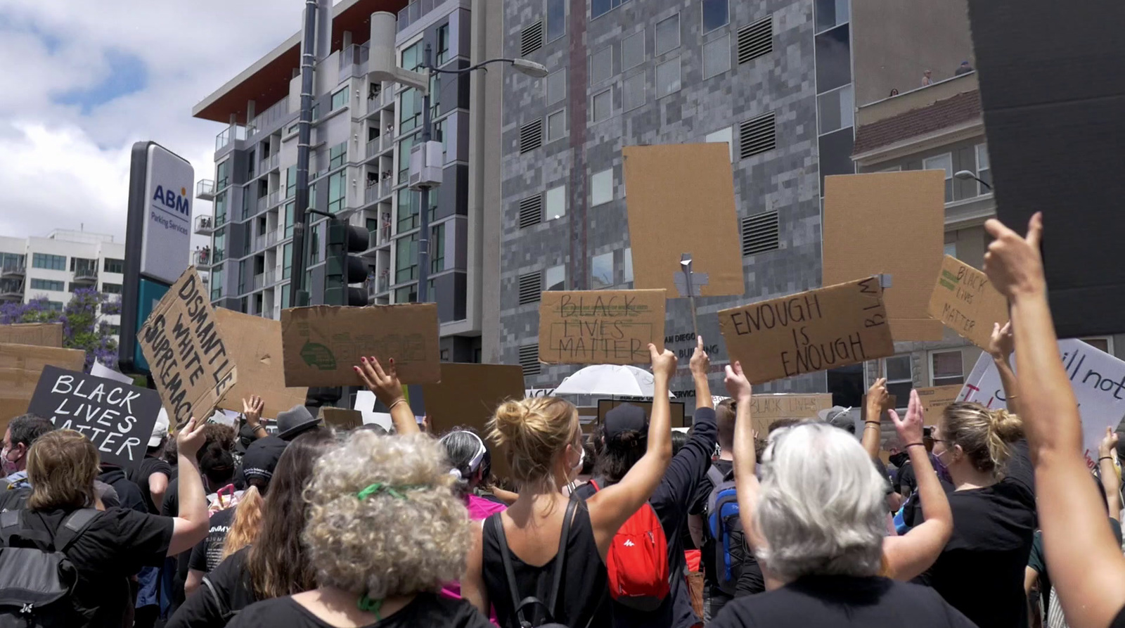 a group of people holding up signs in the air