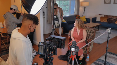 a group of people standing around a living room