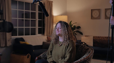 a woman sitting in a chair in a living room