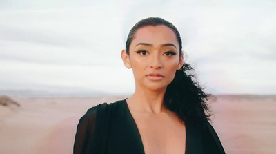 a woman in a black dress posing for a picture