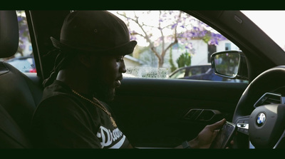 a man sitting in a car holding a cell phone