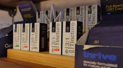 a row of books sitting on top of a wooden shelf