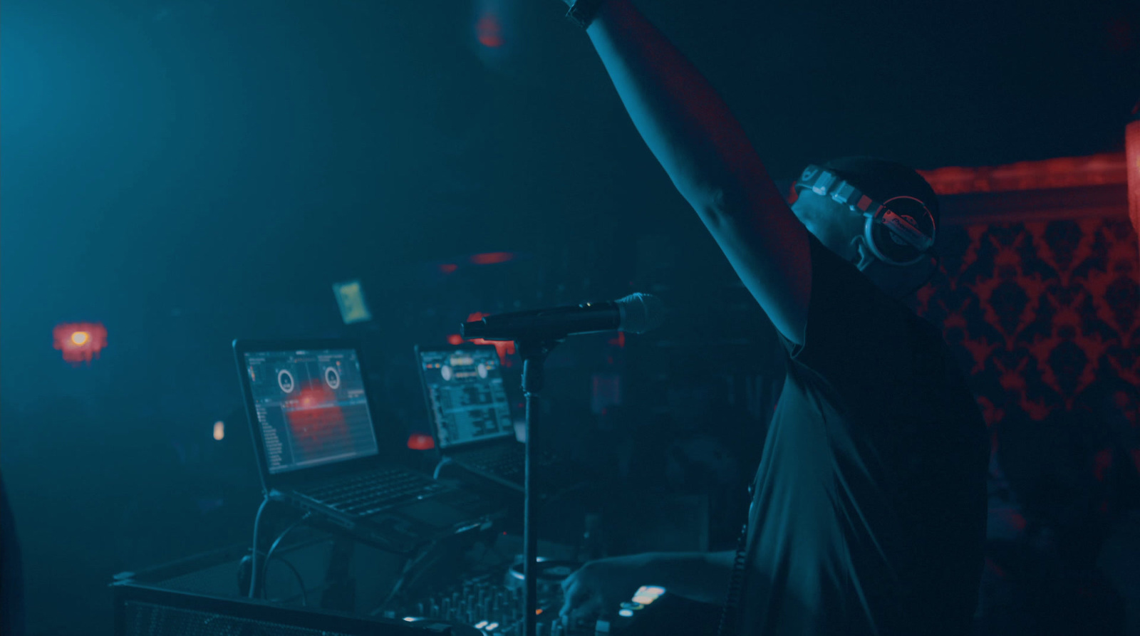 a man in a dark room with headphones on