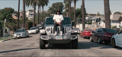 a man sitting on the hood of a jeep