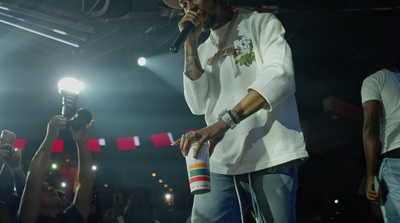 a man standing on a stage holding a microphone