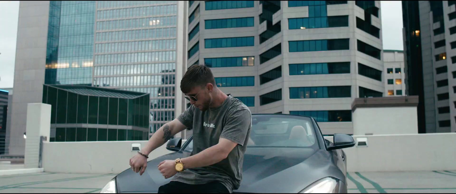 a man sitting on the hood of a car