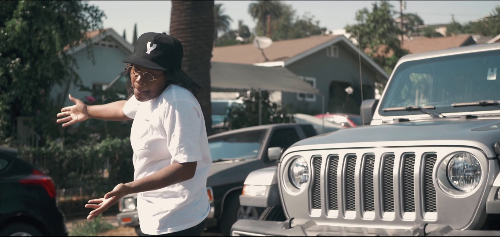 a man standing in front of a jeep in a parking lot