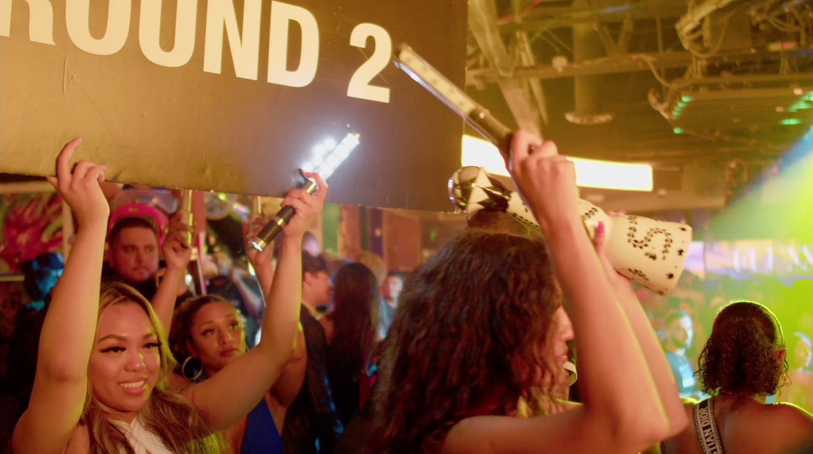 a group of people holding up signs in front of a crowd