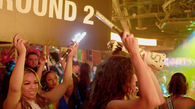 a group of people holding up signs in front of a crowd
