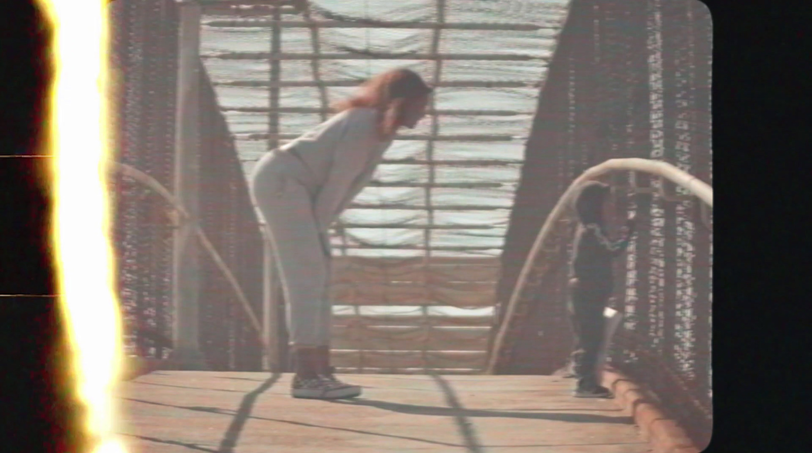 a woman standing on top of a wooden platform