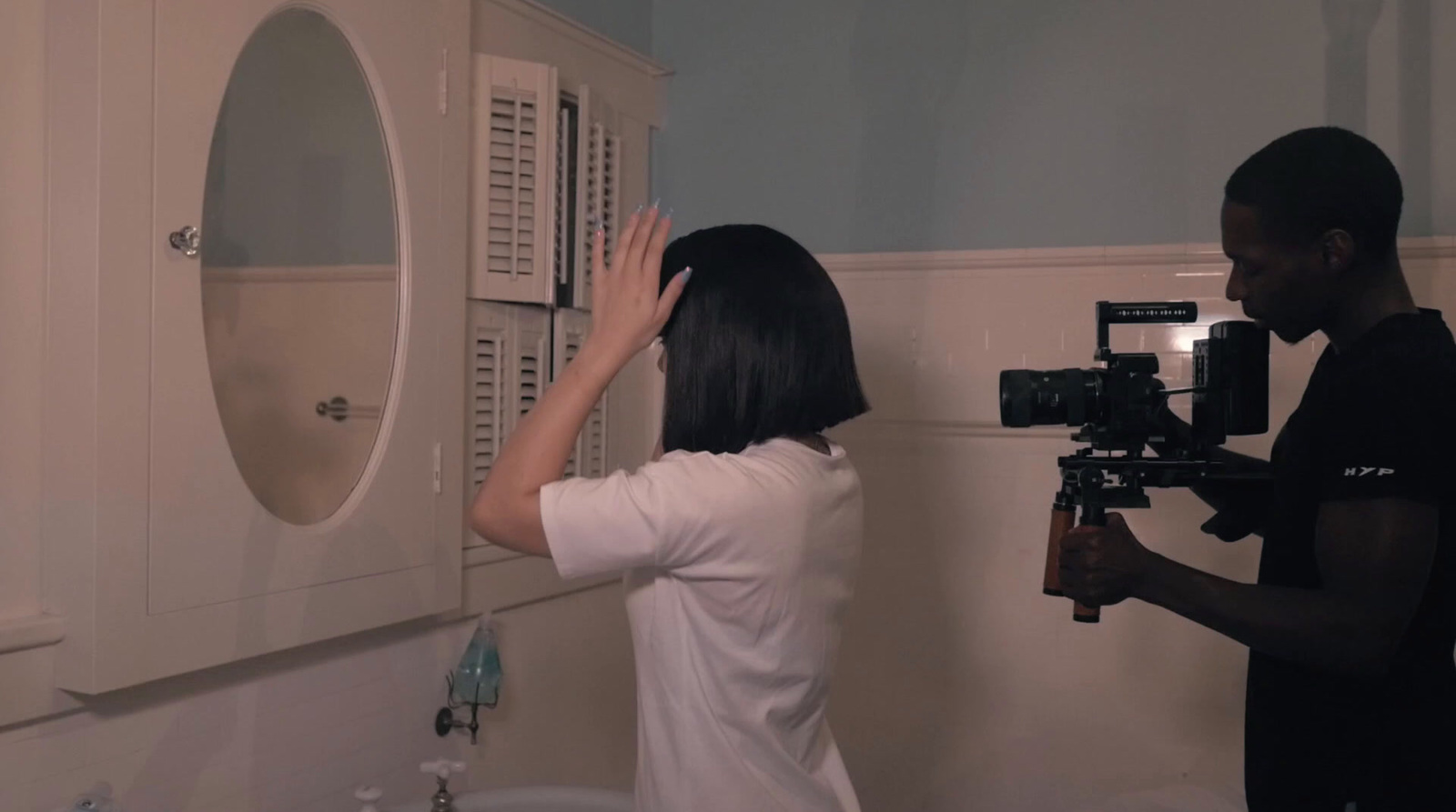 a man and a woman standing in a bathroom