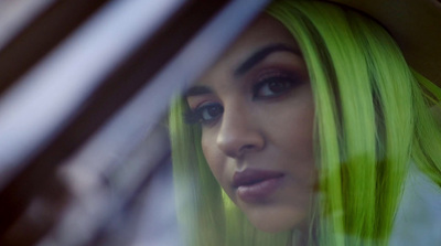 a close up of a person with green hair