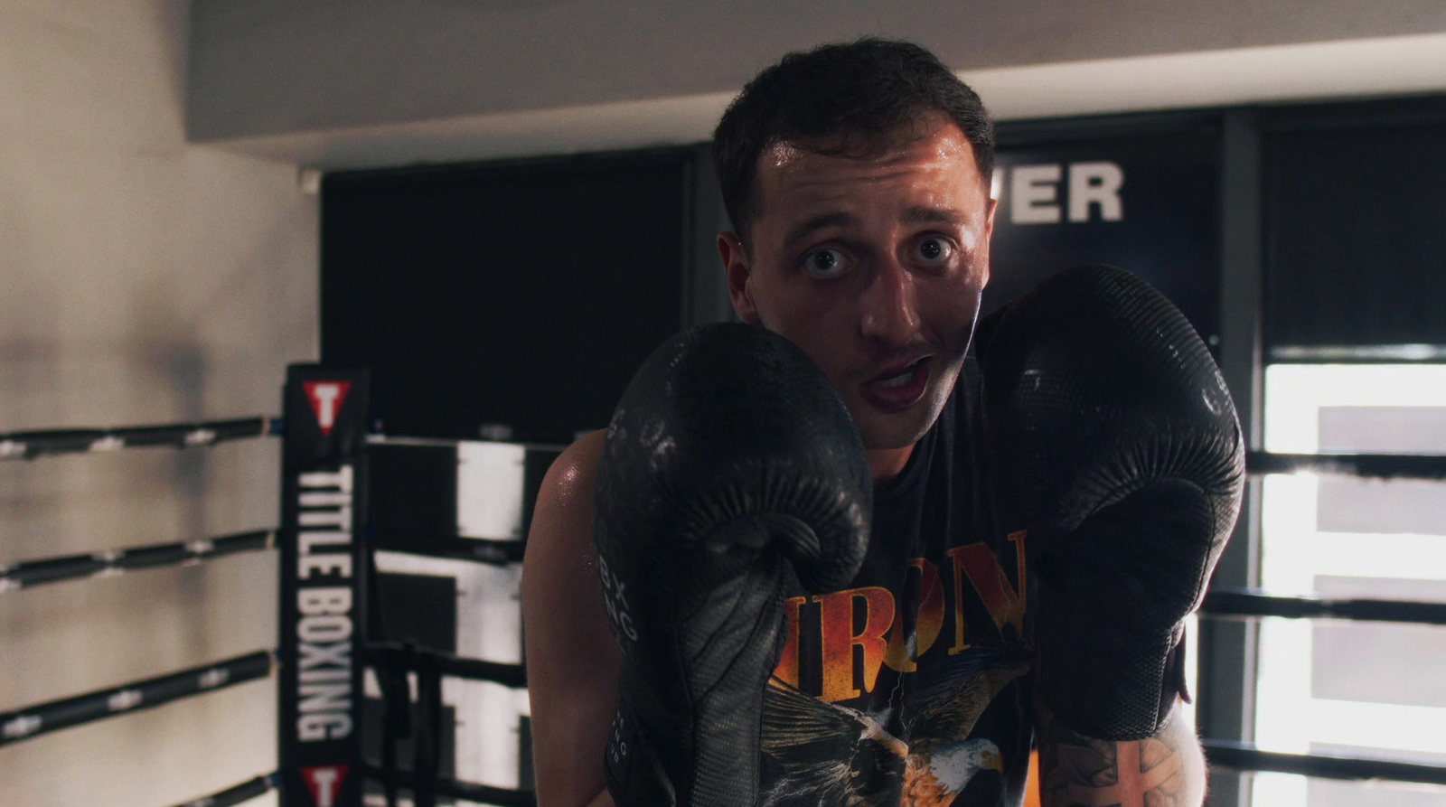 a man wearing boxing gloves in a boxing ring