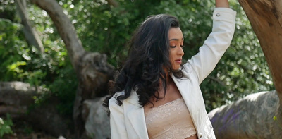 a woman wearing a white jacket and a bra
