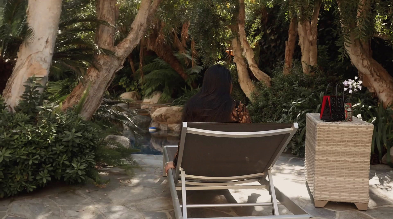 a woman sitting in a chair in a garden