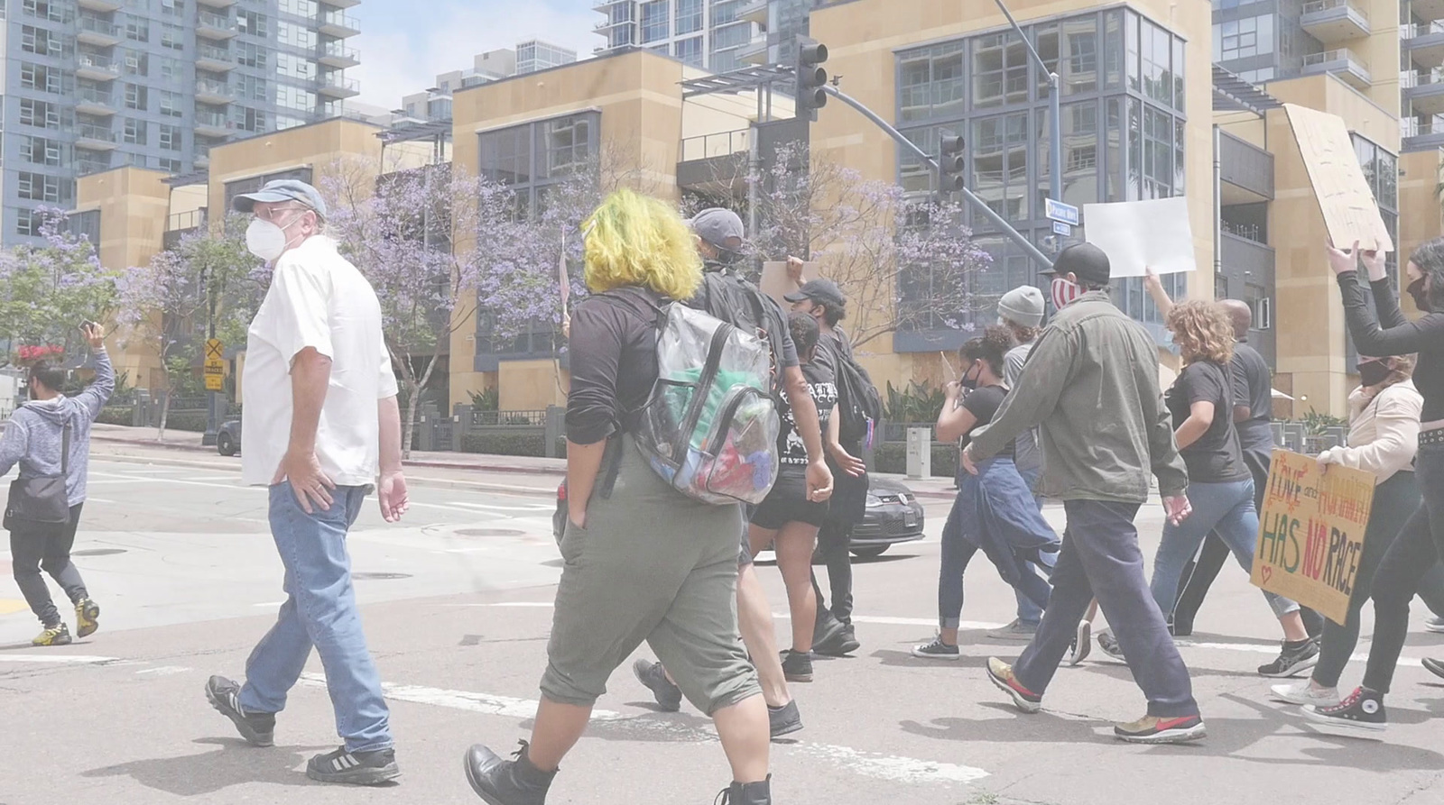 a group of people walking across a street