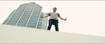 a man standing on top of a white building