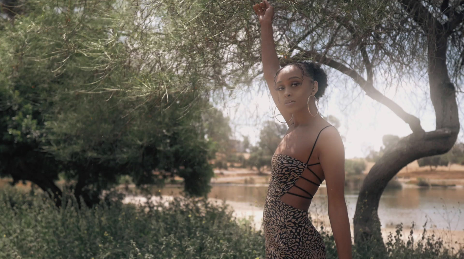 a woman in a leopard print dress holding a frisbee