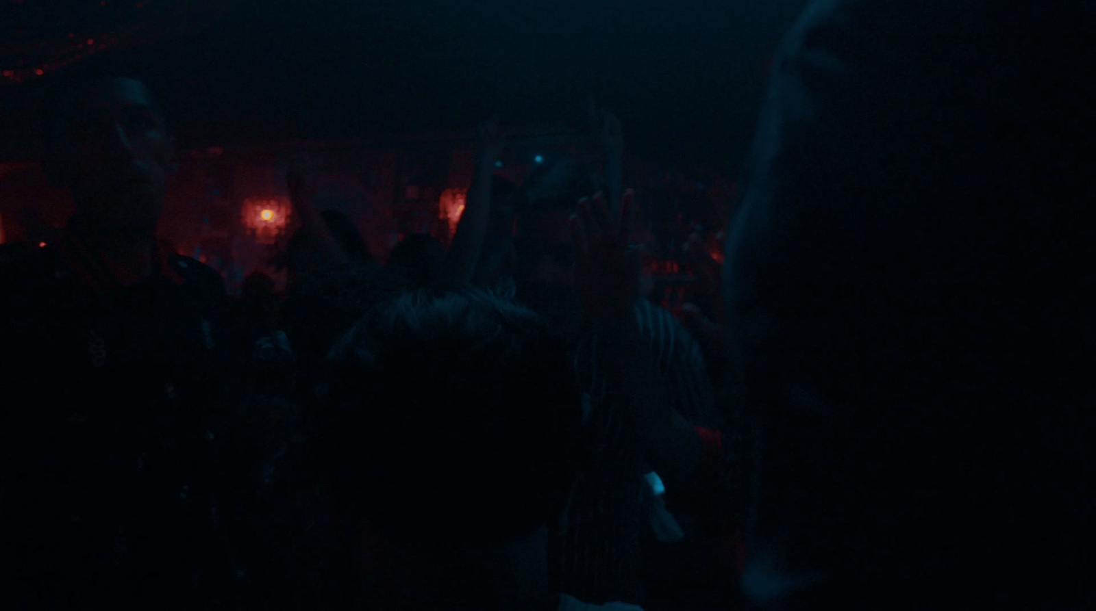 a crowd of people in a dark room