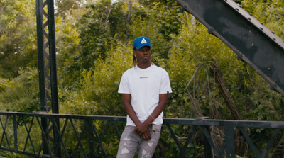 a man riding a skateboard across a bridge