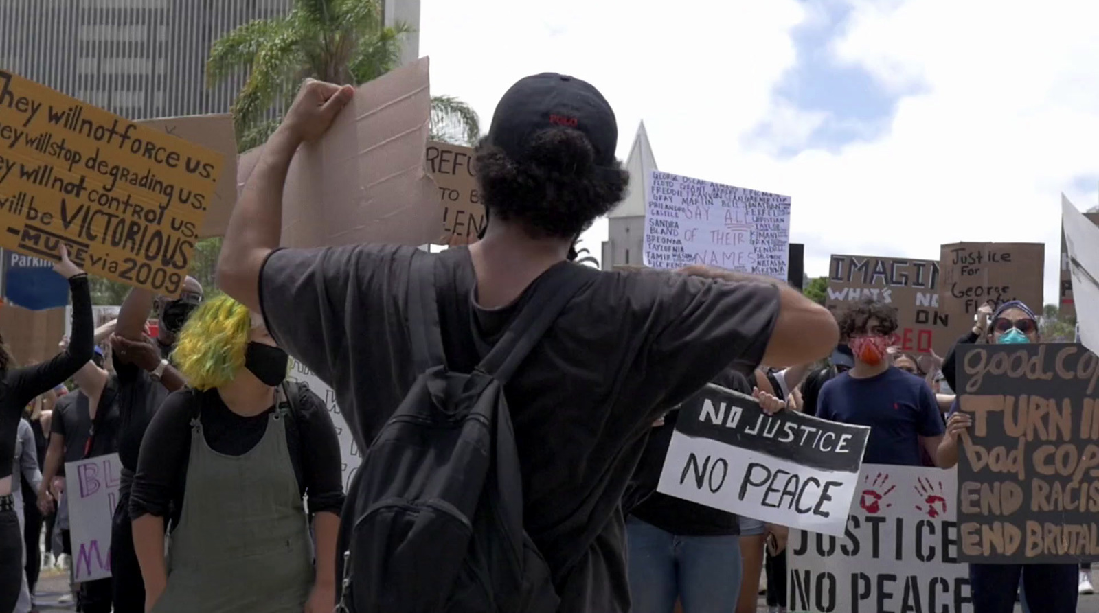 a group of people holding protest signs in front of a building