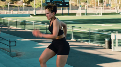 a woman is running on a tennis court