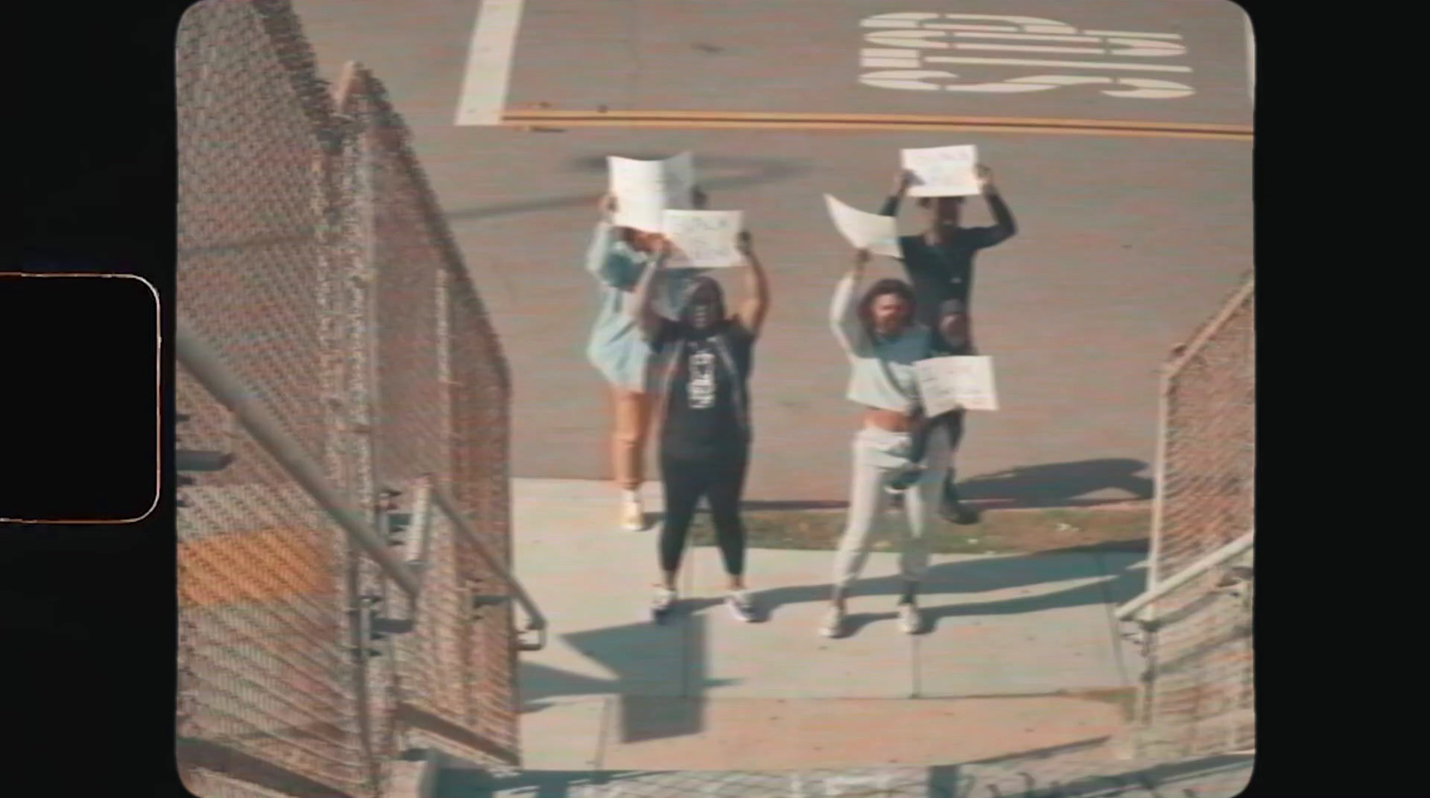 a group of people standing on the side of a road