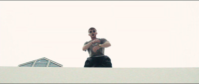 a man standing on top of a roof holding a frisbee