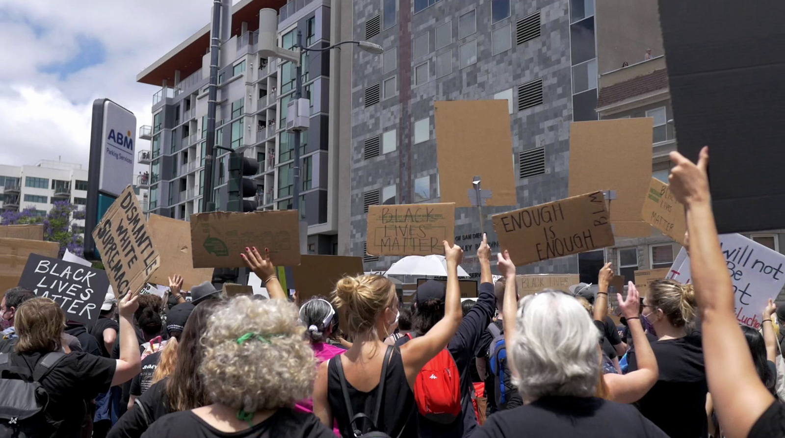 a group of people holding up signs in the air