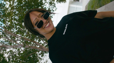 a woman wearing sunglasses and a black shirt