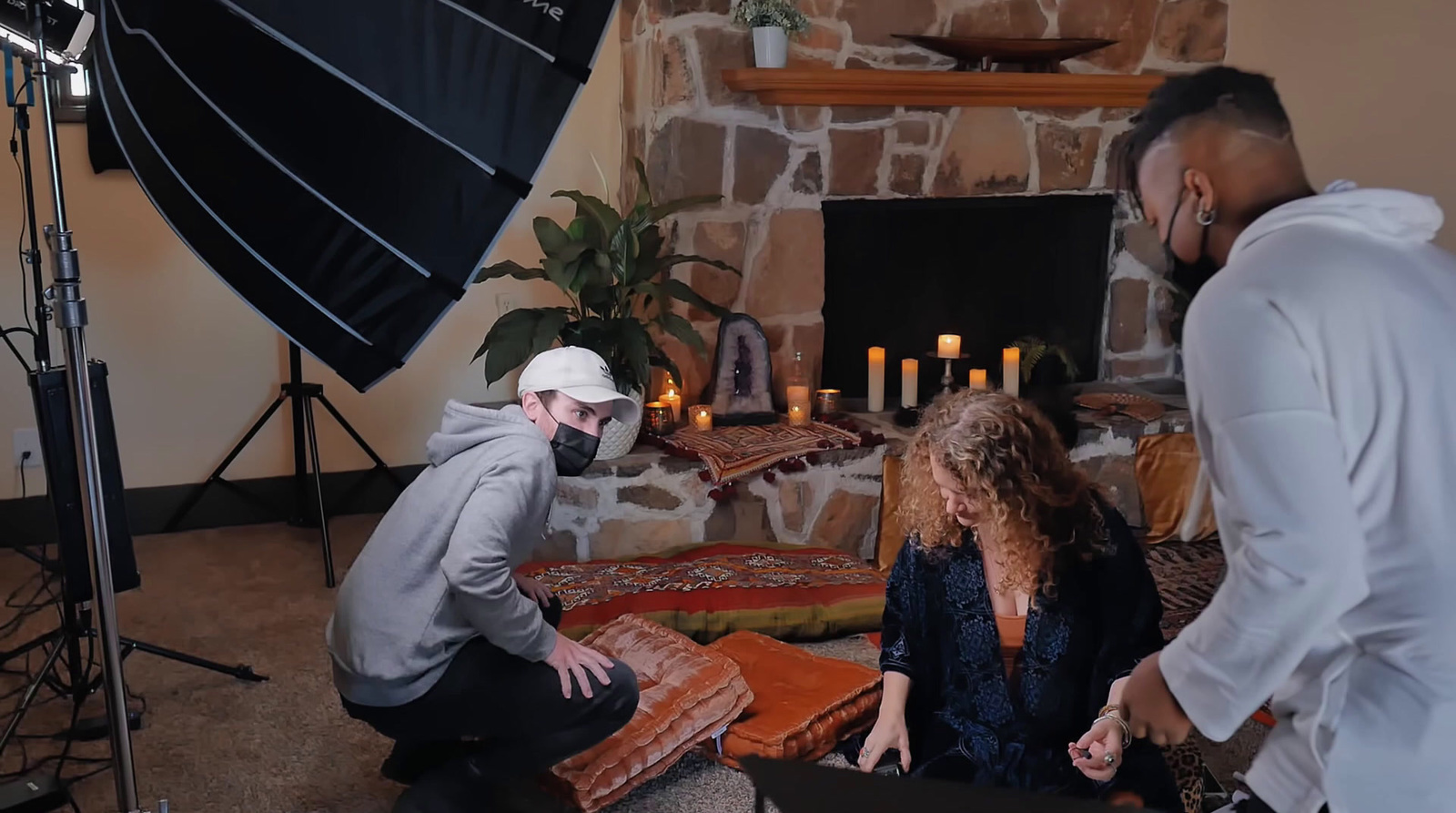 a man and a woman sitting in front of a fireplace