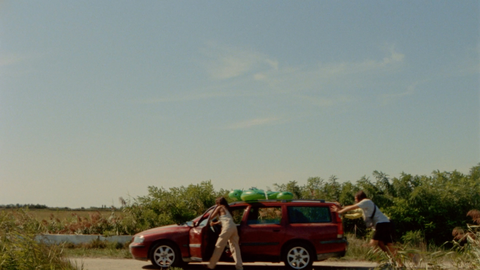 a group of people standing around a red truck