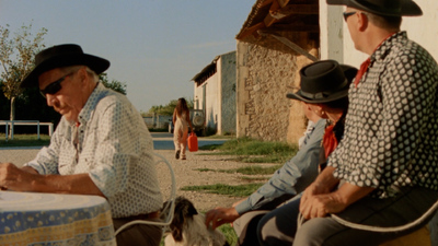 a group of people sitting around a table with a dog