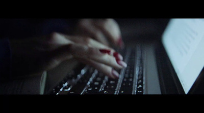 a person is typing on a laptop keyboard