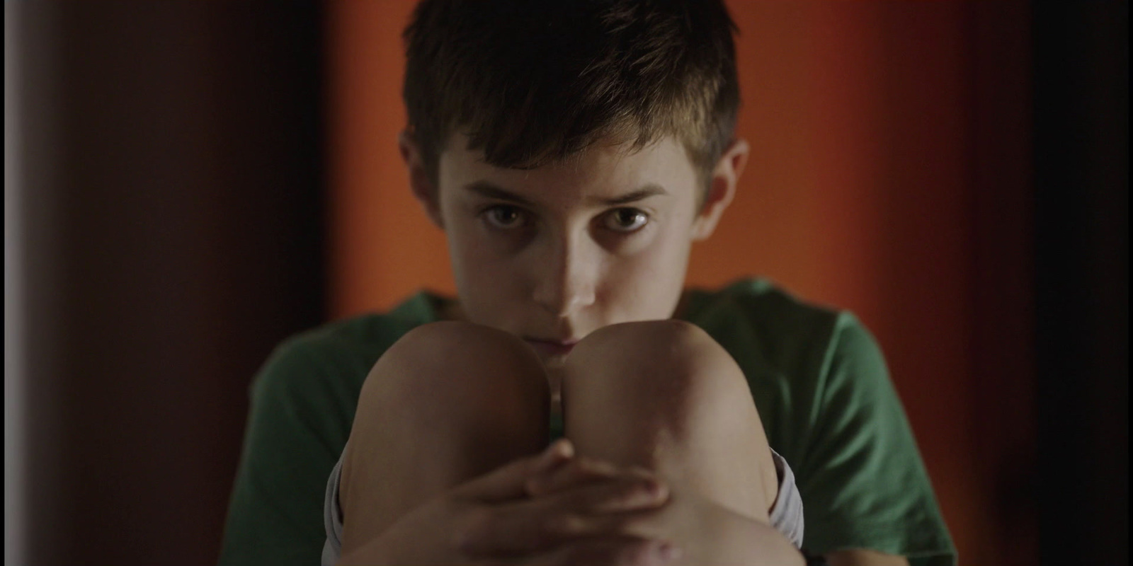 a young boy making a funny face with his finger