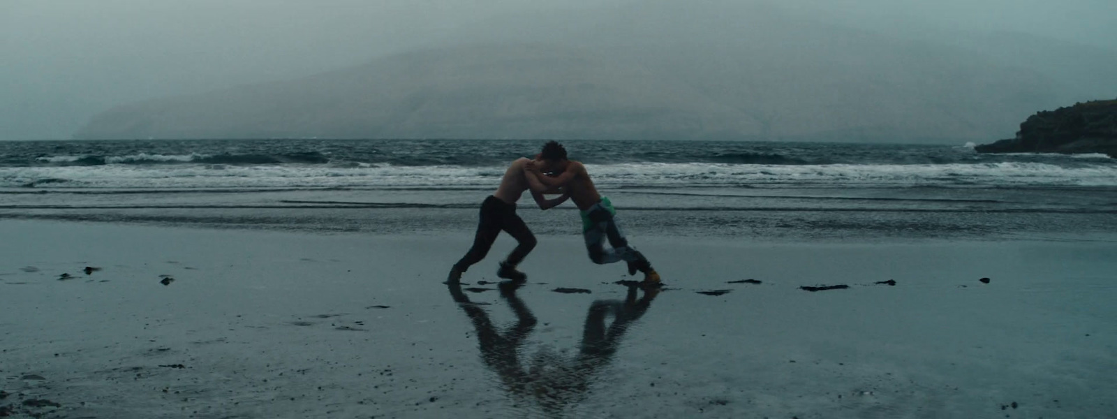 a couple of people that are standing in the sand