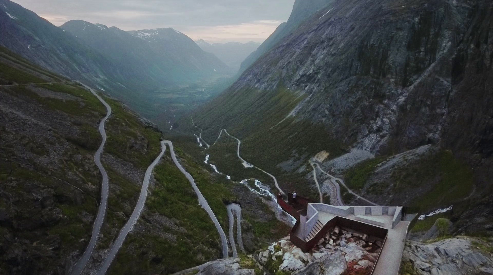 a view of a winding road in a mountain