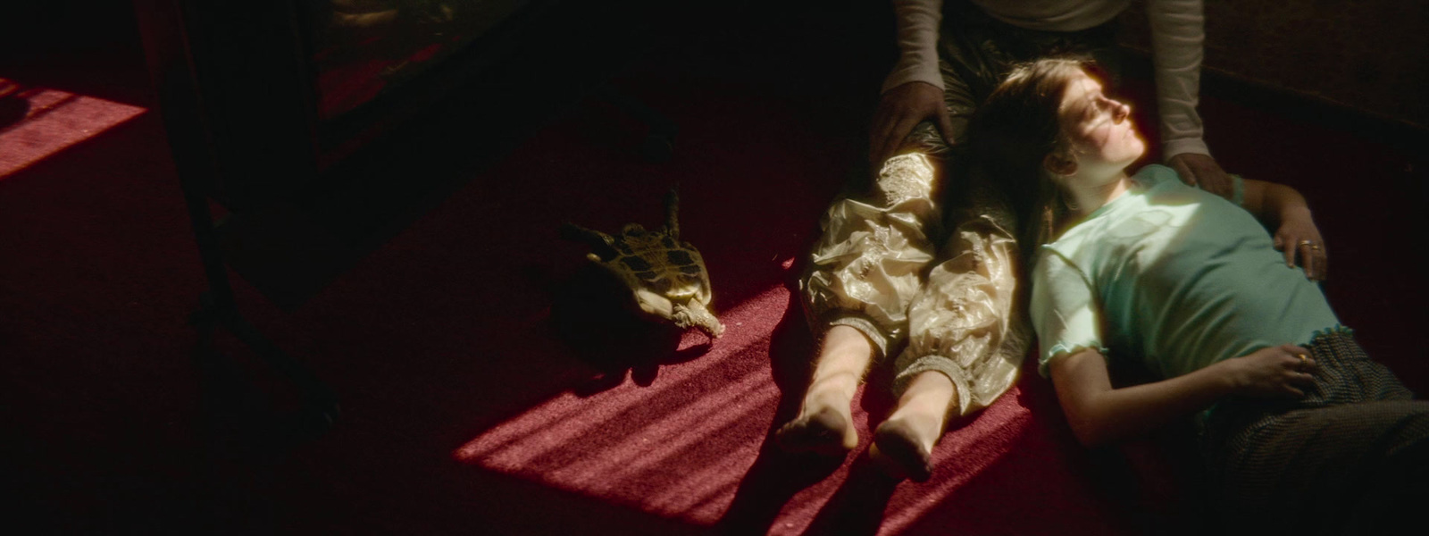 a man and woman laying on the floor in front of a television