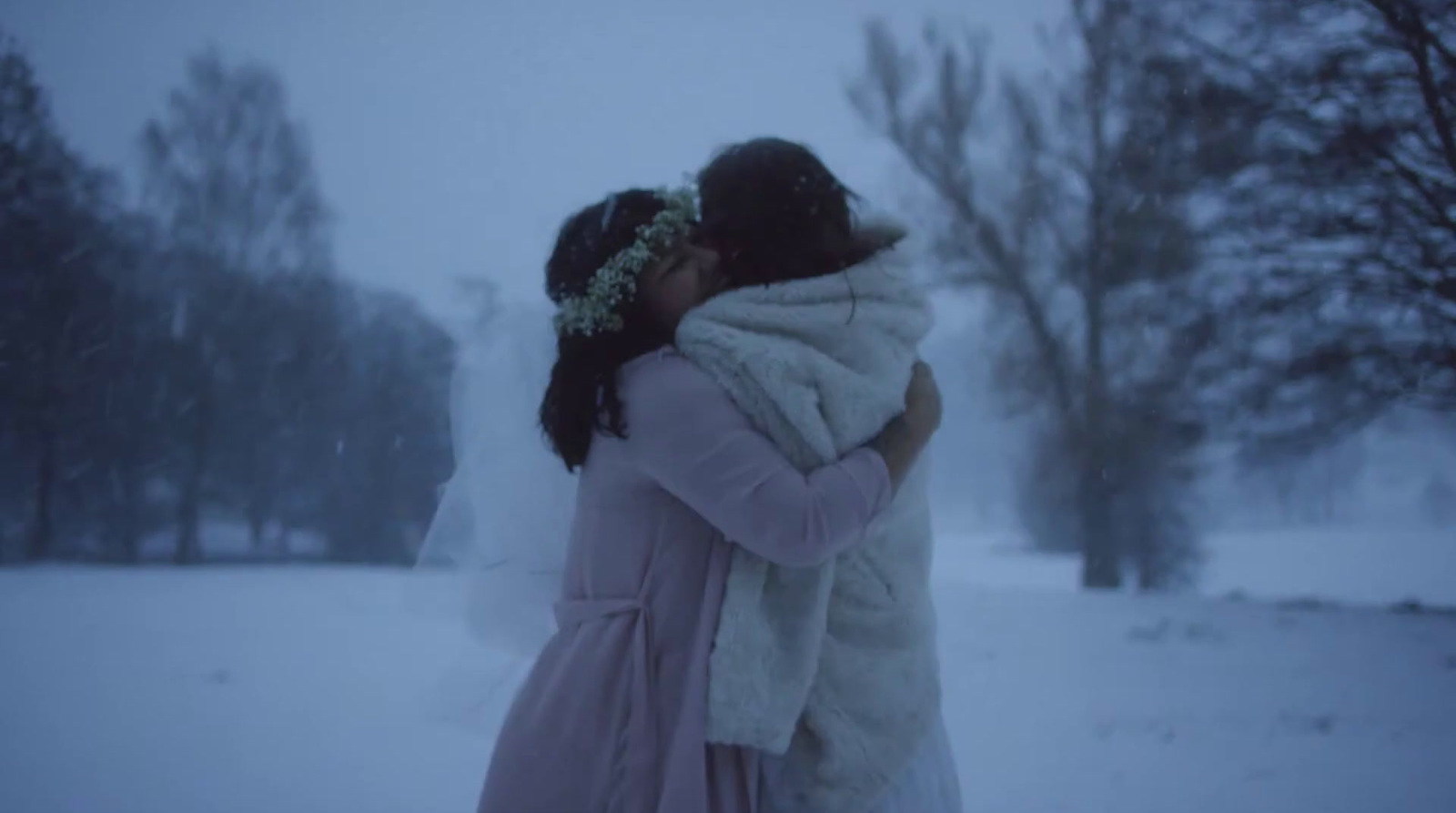 two women hugging in the snow