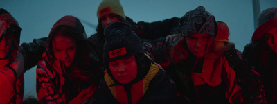 a group of people standing in front of a red light