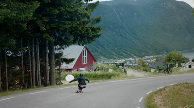 a person is riding a skateboard down a road